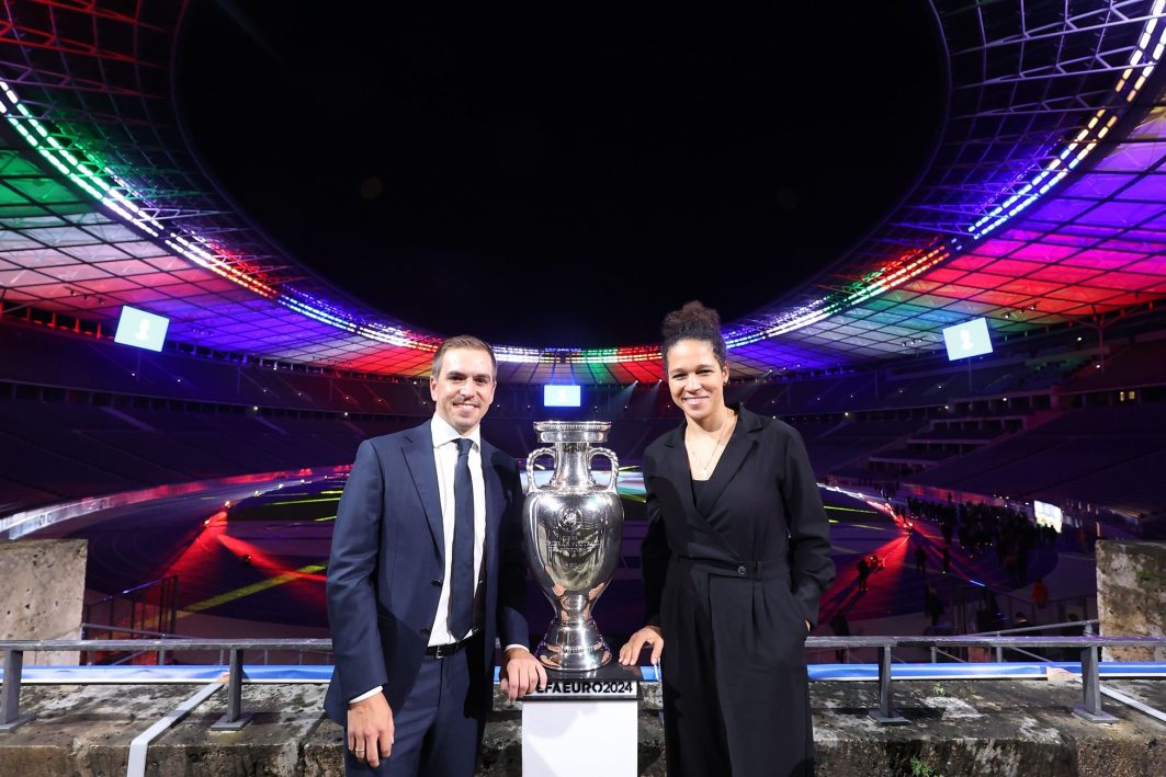 Philipp Lahm, Tournament Director UEFA EURO 2024 and Celia Sasic, Tournament Ambassador UEFA EURO 2024 poses with the UEFA EURO 2024 Winners Trophy during the UEFA EURO 2024 Brand Launch at Olympiastadion on October 05, 2021 in Berlin, Germany.